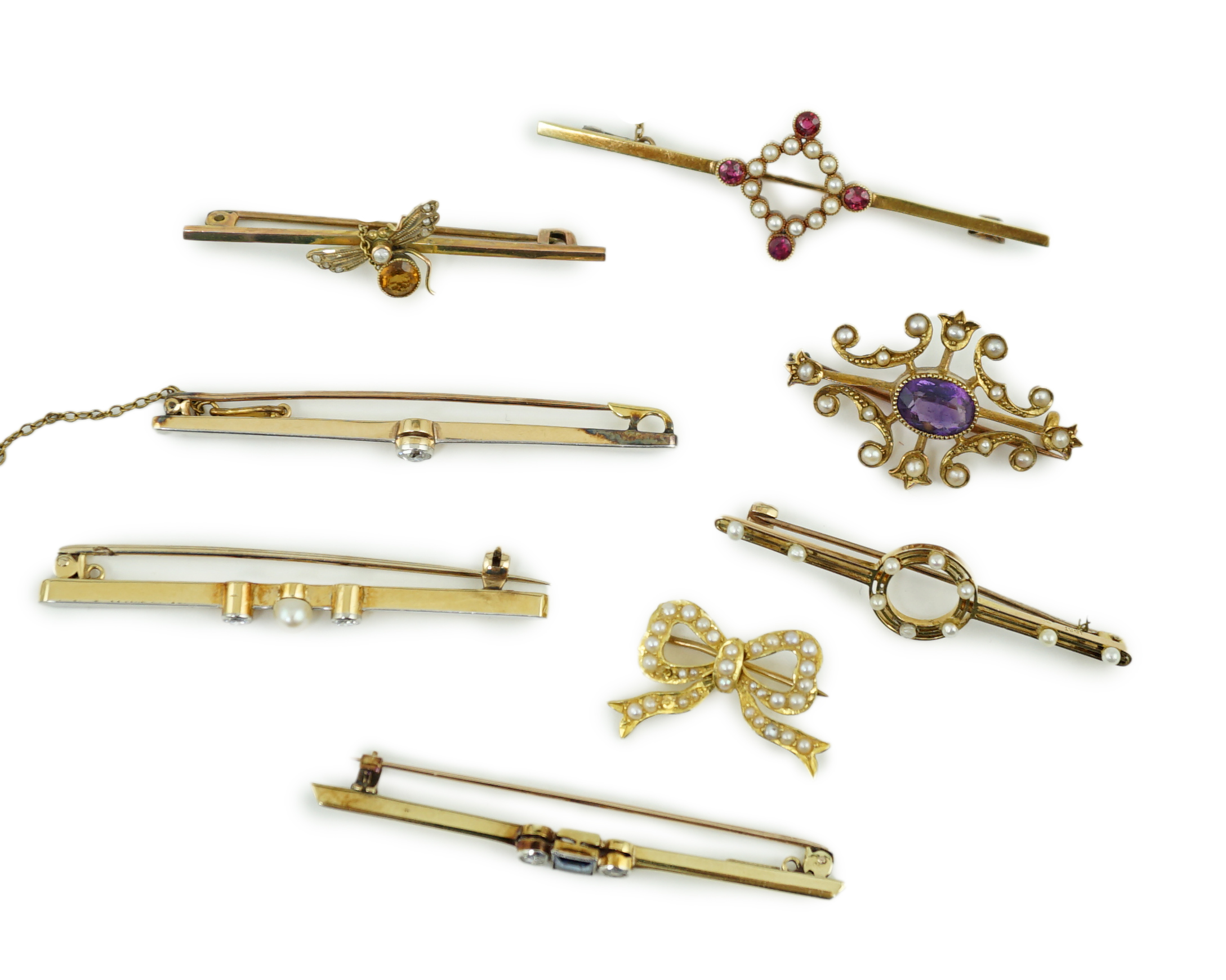 Five assorted Edwardian bar brooches, including a 15ct gold sapphire and diamond set three stone, a diamond and seed pearl, ruby? and seed pearl, a solitaire diamond set and a seed pearl and citrine bug brooch